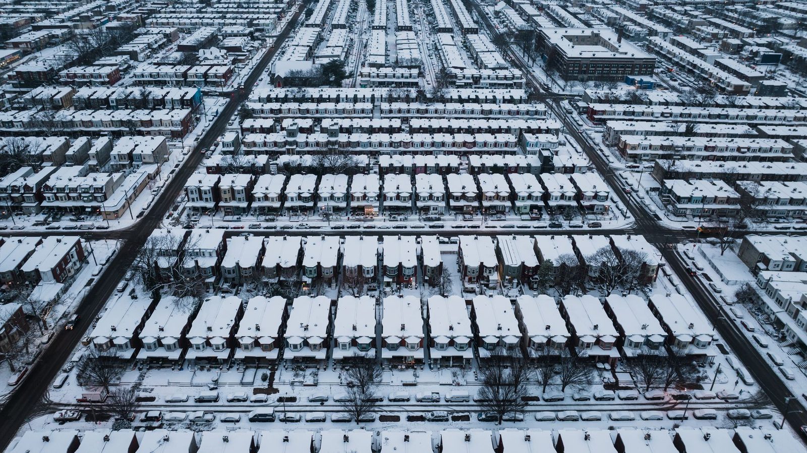 Aerial view of snow-covered Philadelphia row houses in a dense street grid